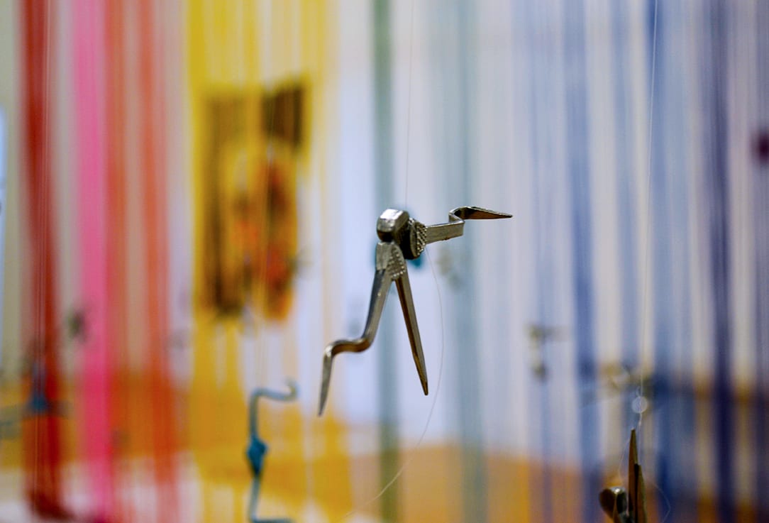 Horseshoe nail sculpture dangles from the ceiling.