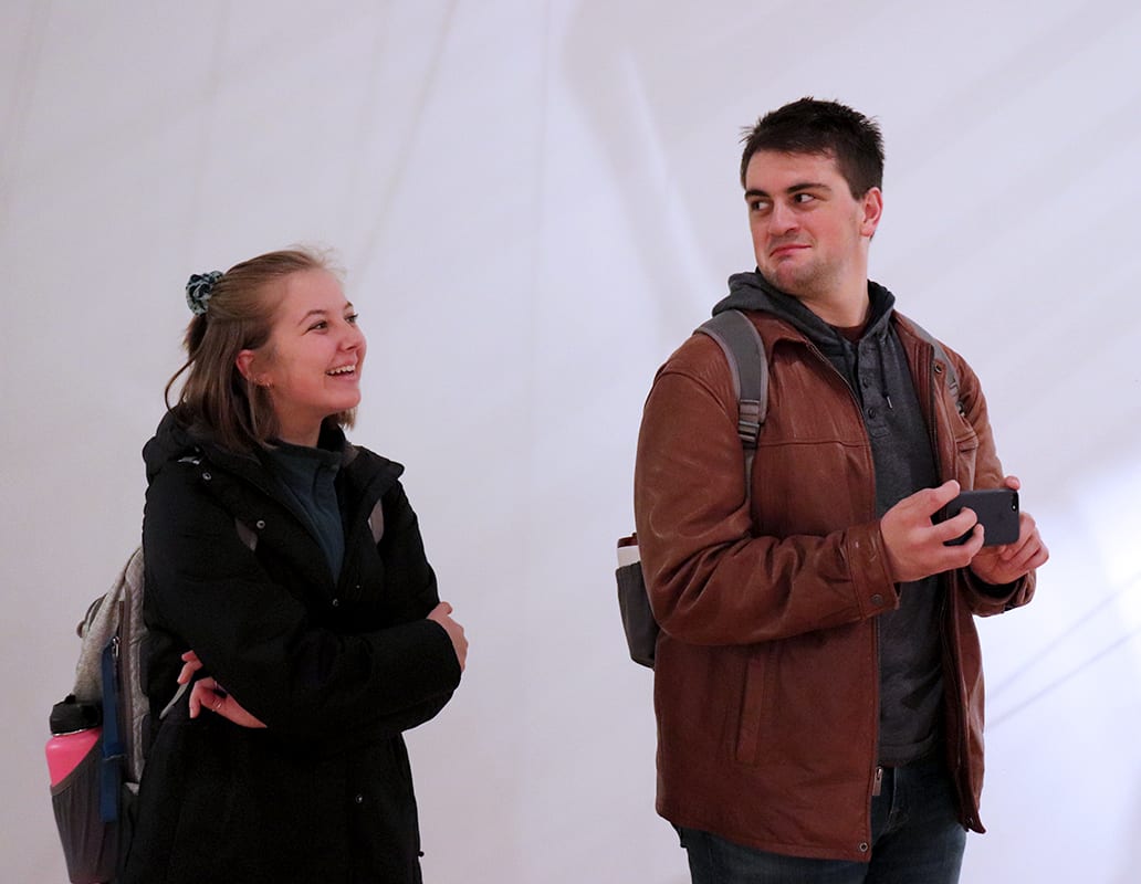 Students attend the opening of John Umphlett's Elements of Degradation.