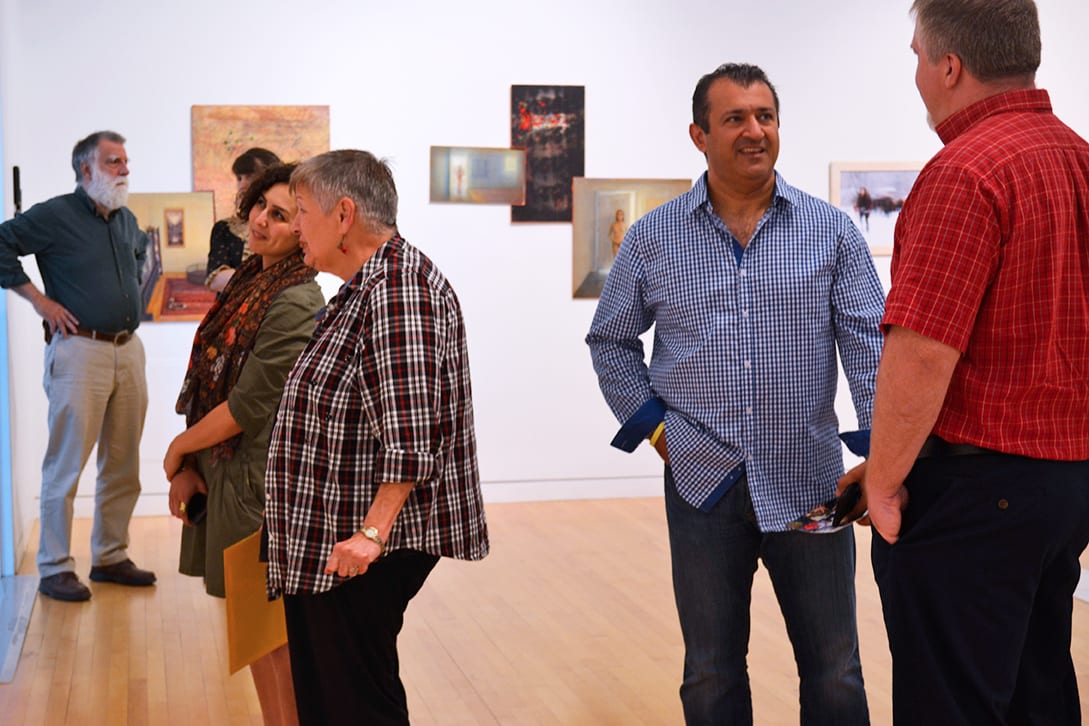 Visitors discuss artwork from the exhibition.
