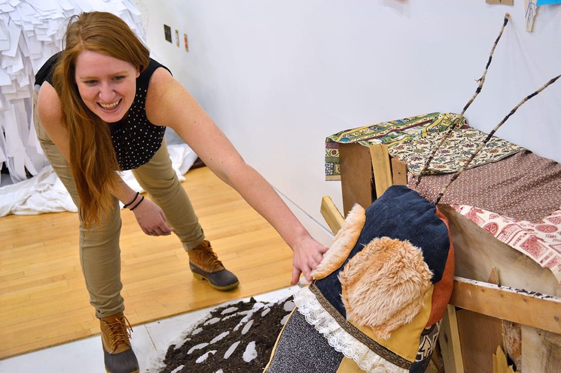 A student feels the softness of a plush cockroach.
