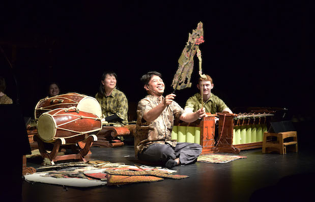 A performer uses a puppet while the concert is performed.