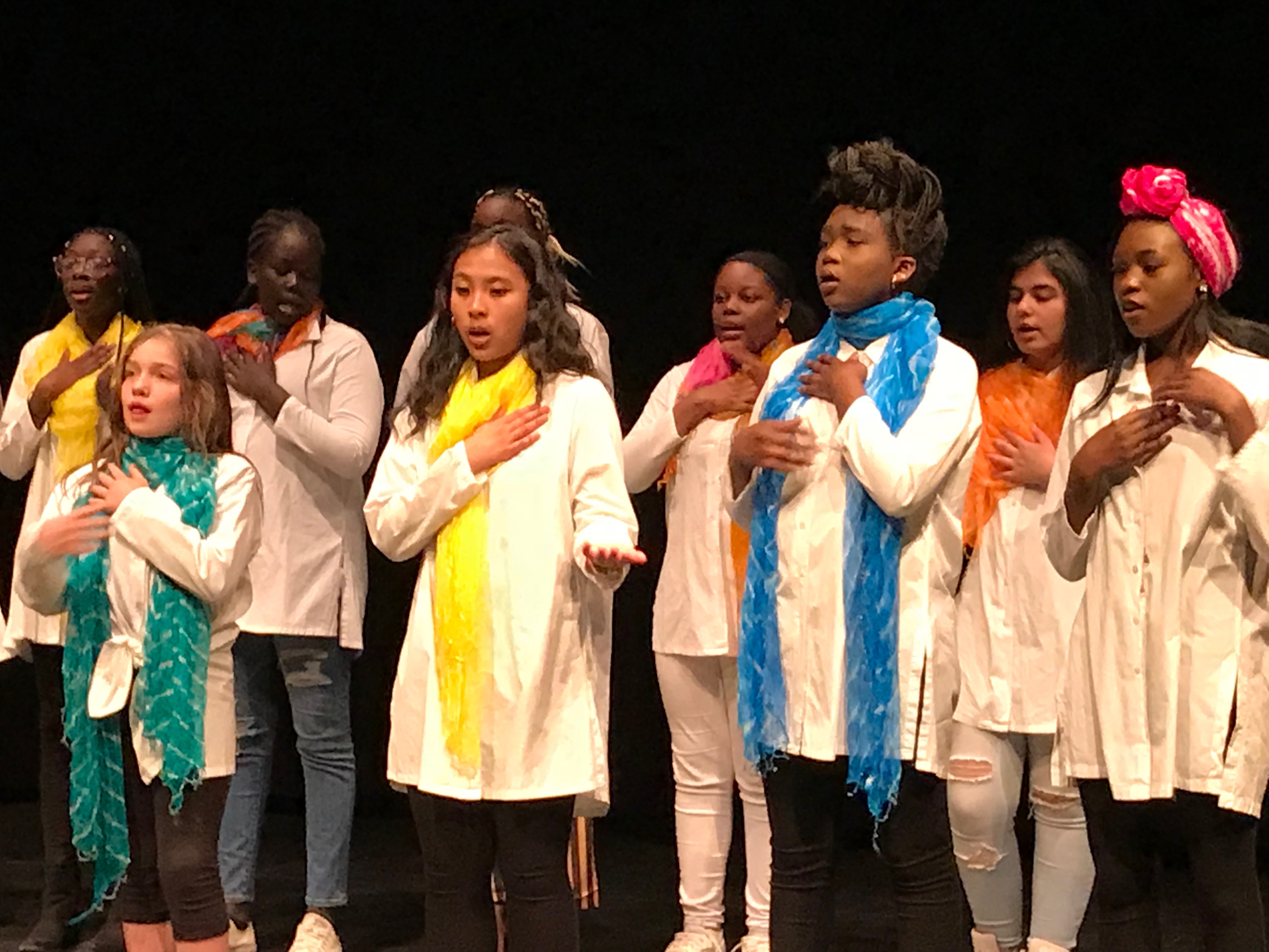 Singers place their hands over their hearts as they perform.