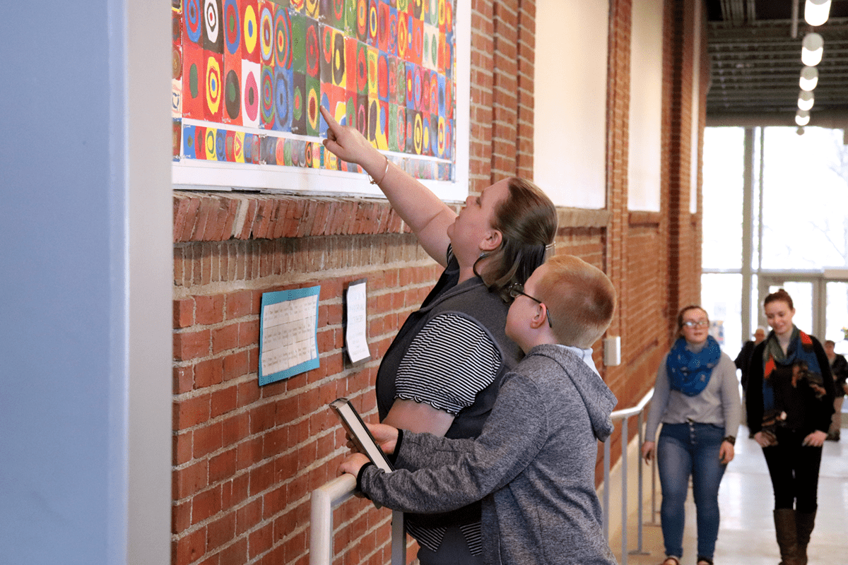Patrons observe the artwork during the MBHS Opening Reception.