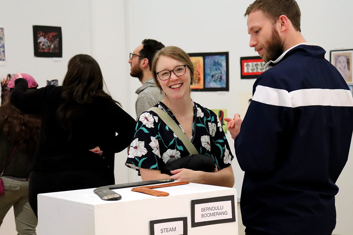 Patrons observe the artwork during the MBHS Opening Reception.