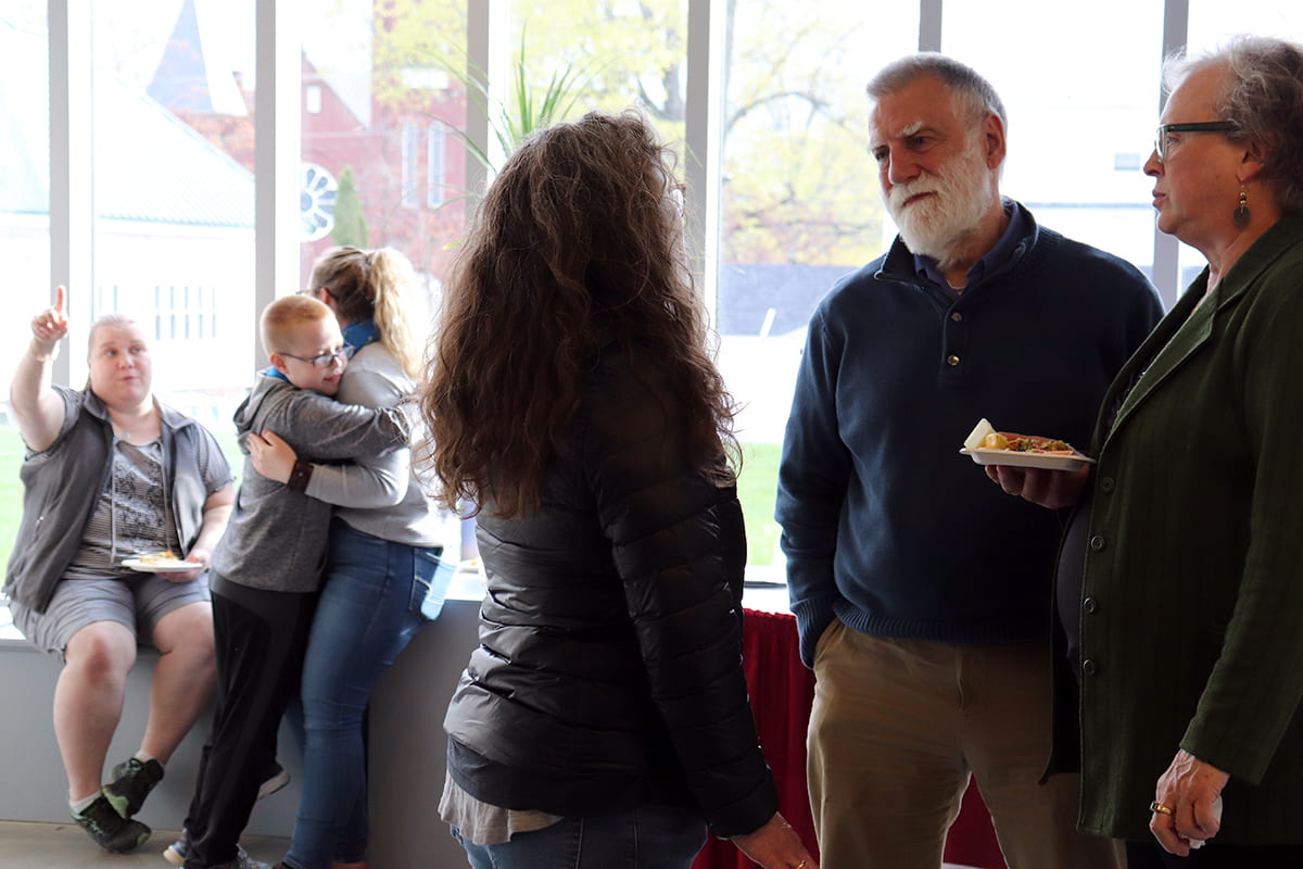 Patrons discuss artwork at the MBHS opening reception.