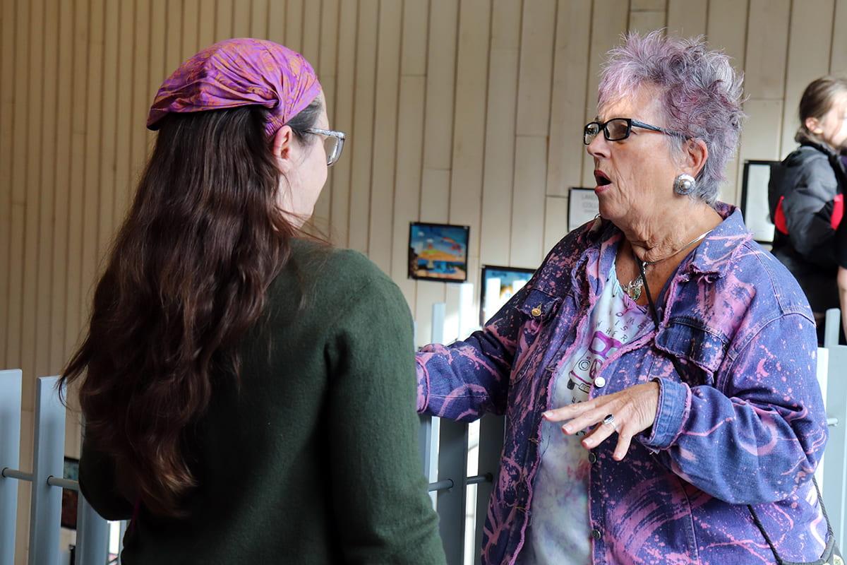 Patrons discuss artwork at the MBHS opening reception.