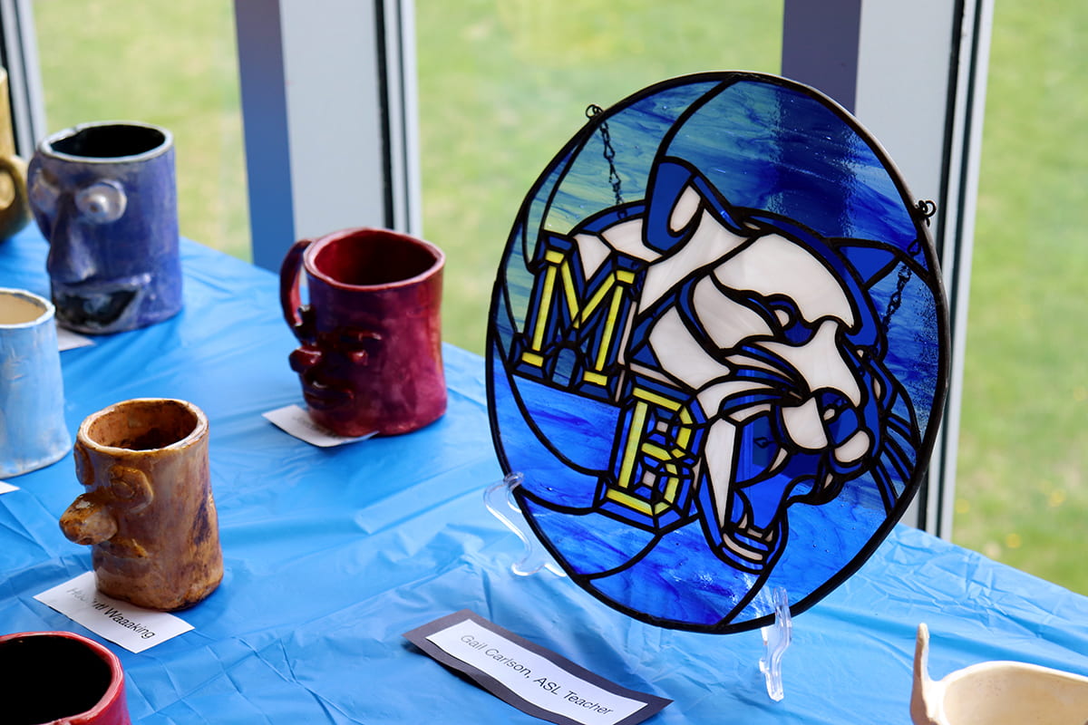 A stained glass work of the MBHS logo.