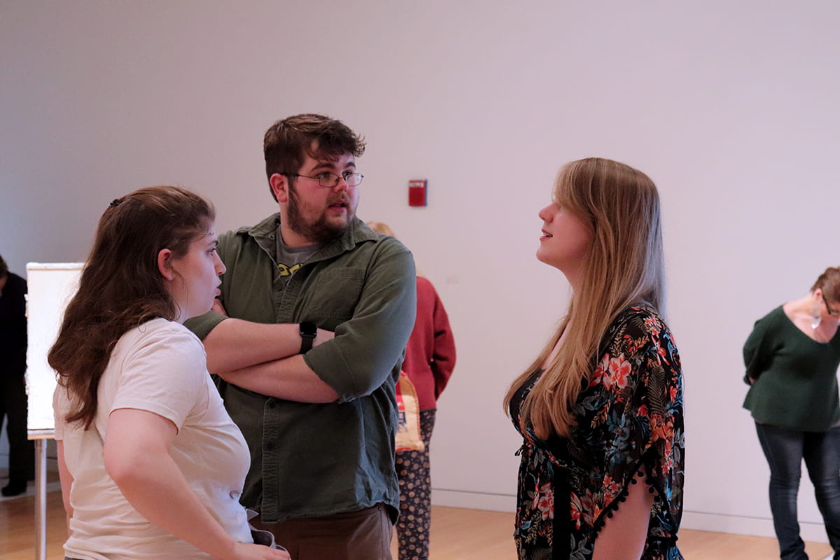 An Artist chats with gallery guests.