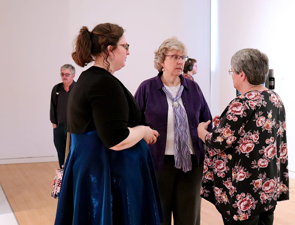 An artist talks with community members.
