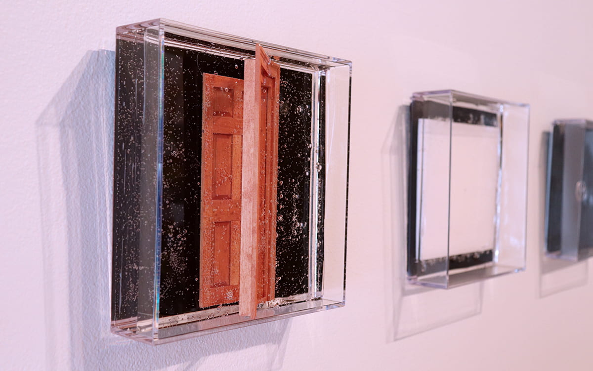 Small objects are preserved in gel for this artwork.