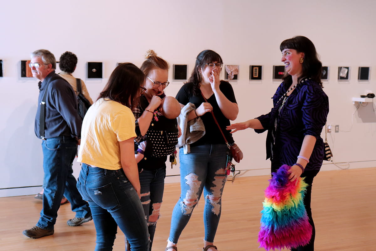 An artist laughs with some friends.