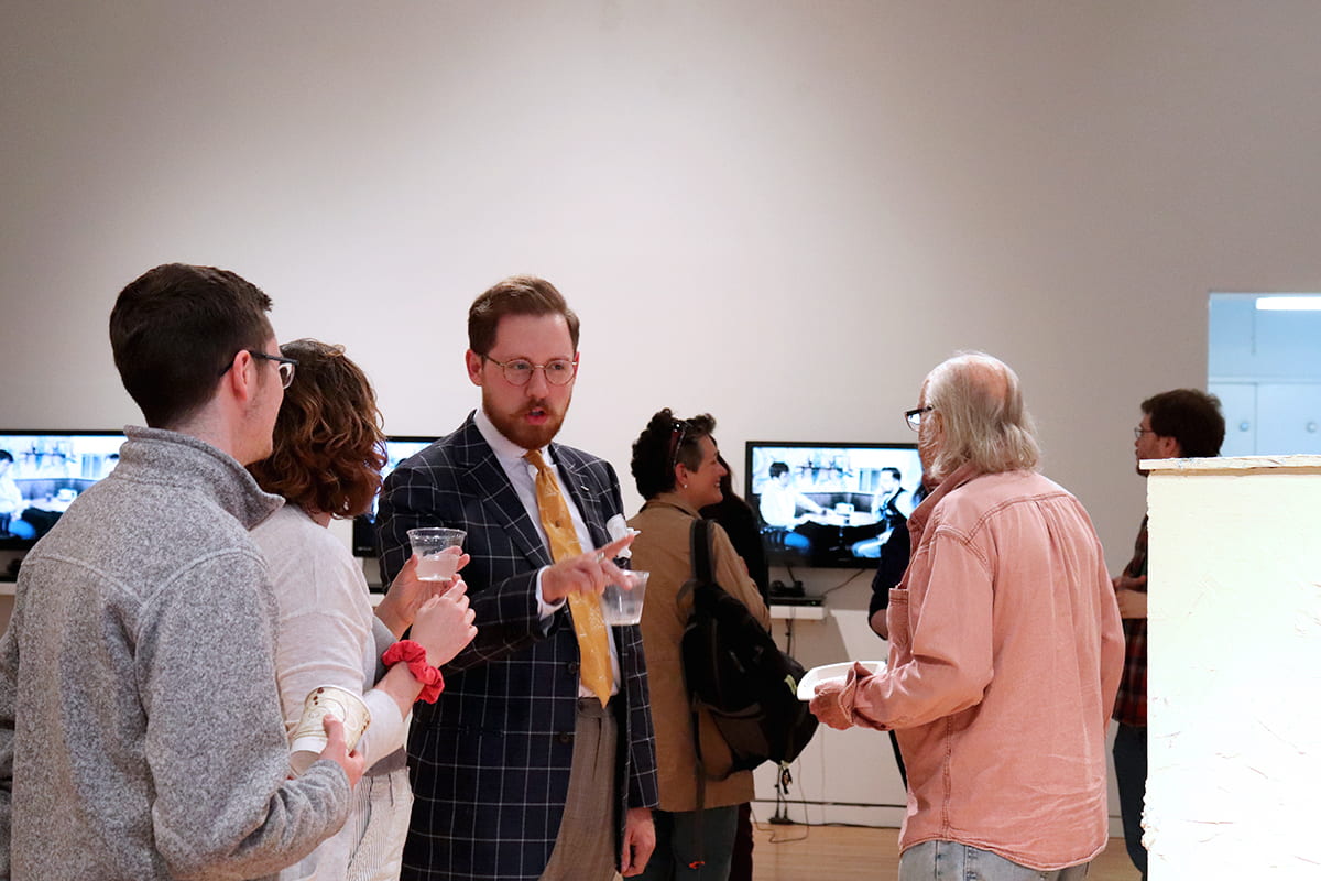 Community members discuss artwork in the gallery.