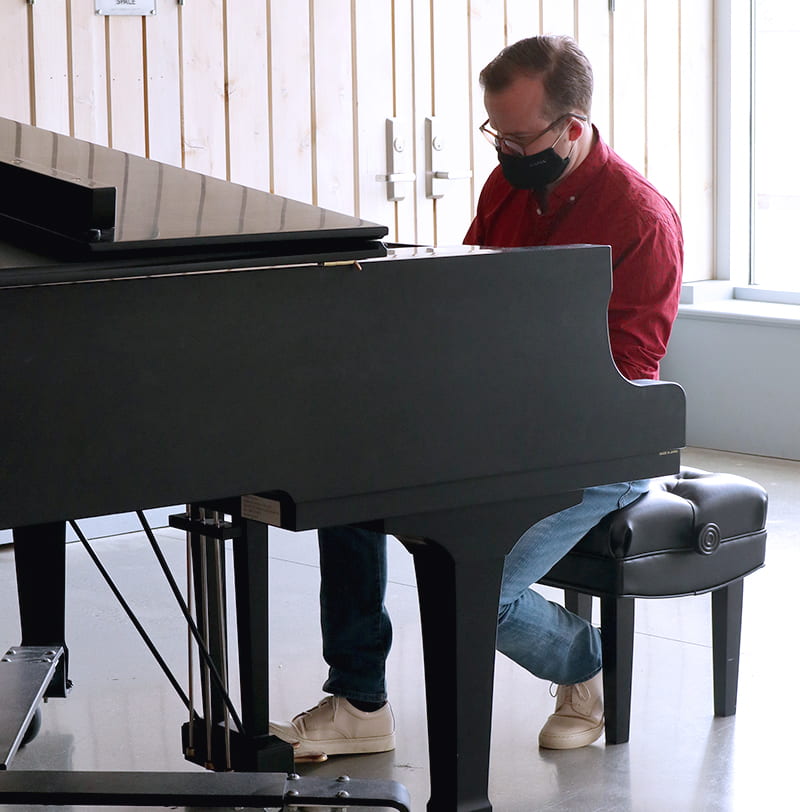 Aaron Wyanksi Performing on the Piano for Liminal Spaces.